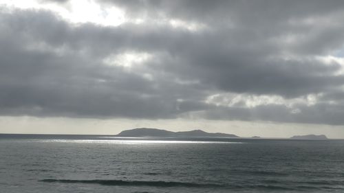 Scenic view of sea against storm clouds