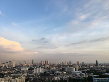 Aerial view of buildings in city against sky