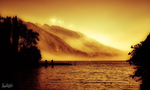 Scenic view of lake against sky during sunset