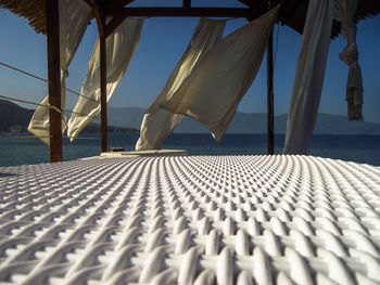 Chairs on beach against clear blue sky