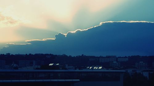 Cityscape against cloudy sky