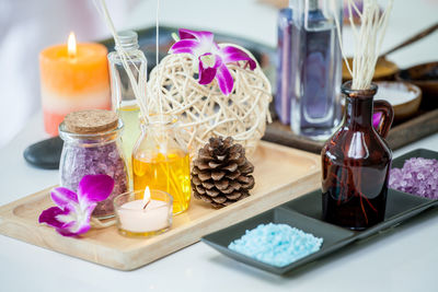 Close-up of various flowers in glass container on table