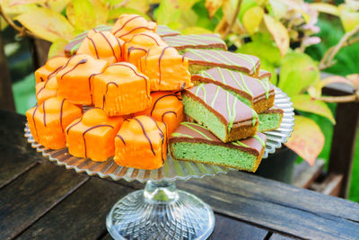 Close-up of dessert on cakestand at table