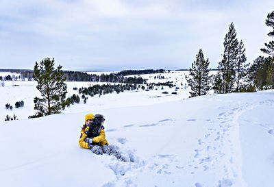 View of snow covered field against sky