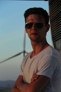 Portrait of young man wearing sunglasses against sky