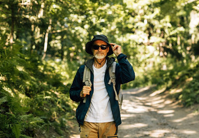 Portrait of young man wearing sunglasses standing outdoors