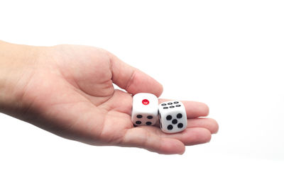 Close-up of hand holding hands over white background