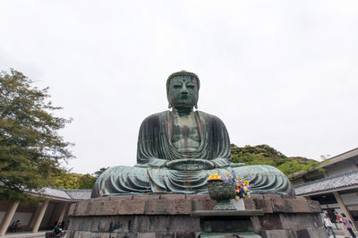 Low angle view of statue against sky