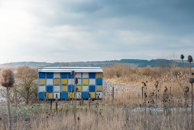 View of beehive on field against sky