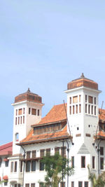 Low angle view of buildings against clear blue sky
