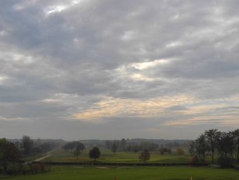 Scenic view of landscape against cloudy sky