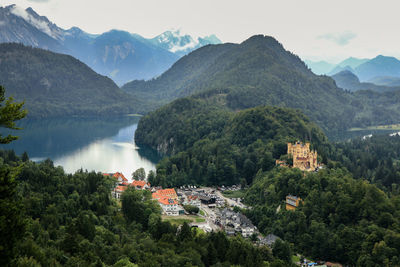 Hohenschwangau castle
scenic view of townscape by mountains against sky 