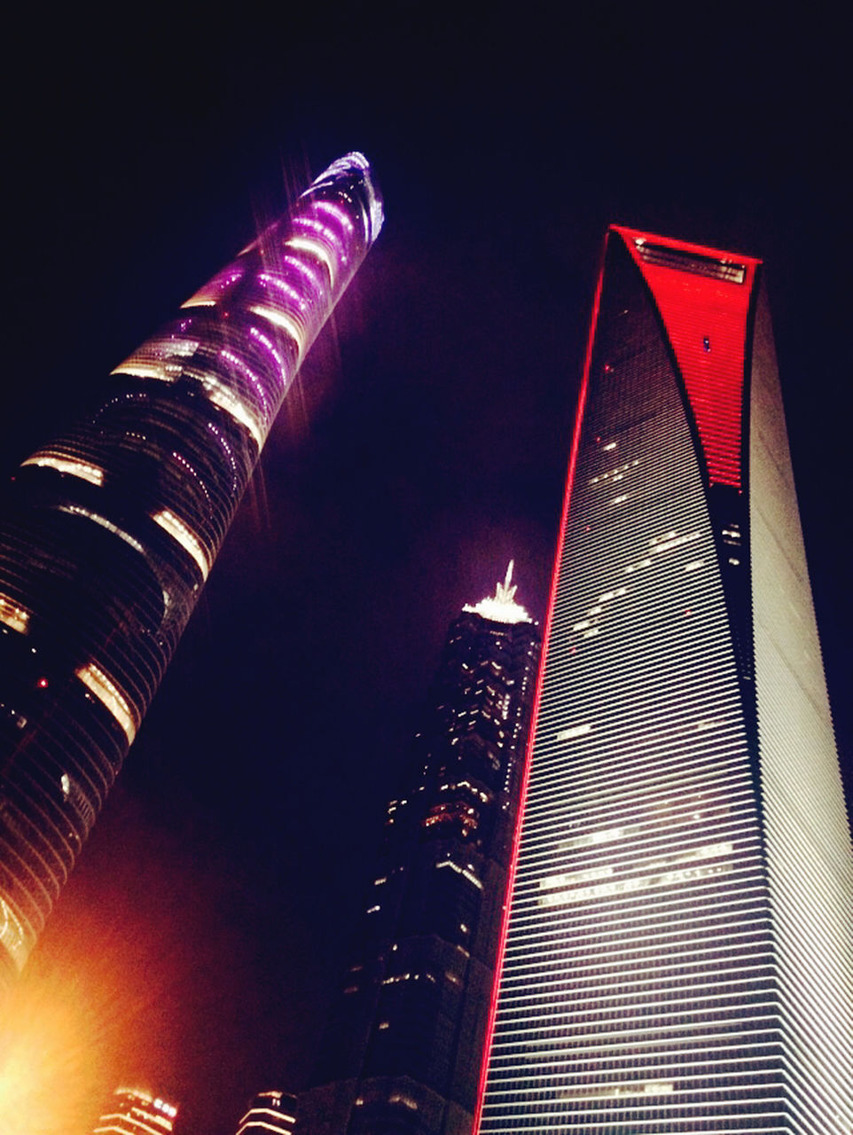 low angle view, illuminated, night, modern, built structure, architecture, skyscraper, tall - high, building exterior, sky, tower, city, red, arts culture and entertainment, outdoors, no people, capital cities, office building, american flag, famous place