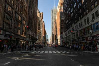 Group of people crossing road in city