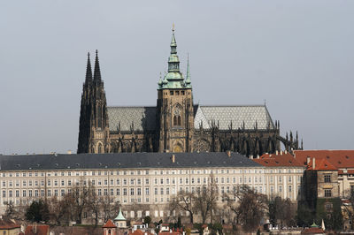 Buildings in city against clear sky