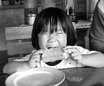 Portrait of cute child eating sandwich