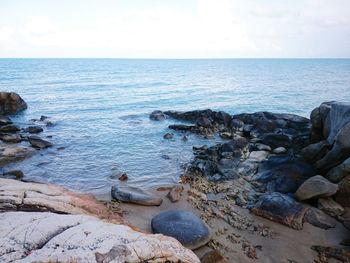 Rocks in sea against sky