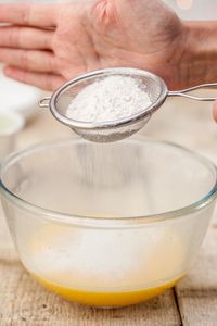 Close-up of man preparing food in bowl on table