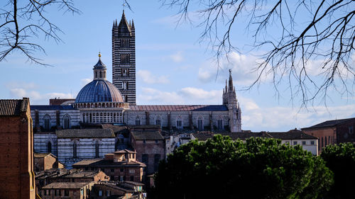 Buildings in city against sky