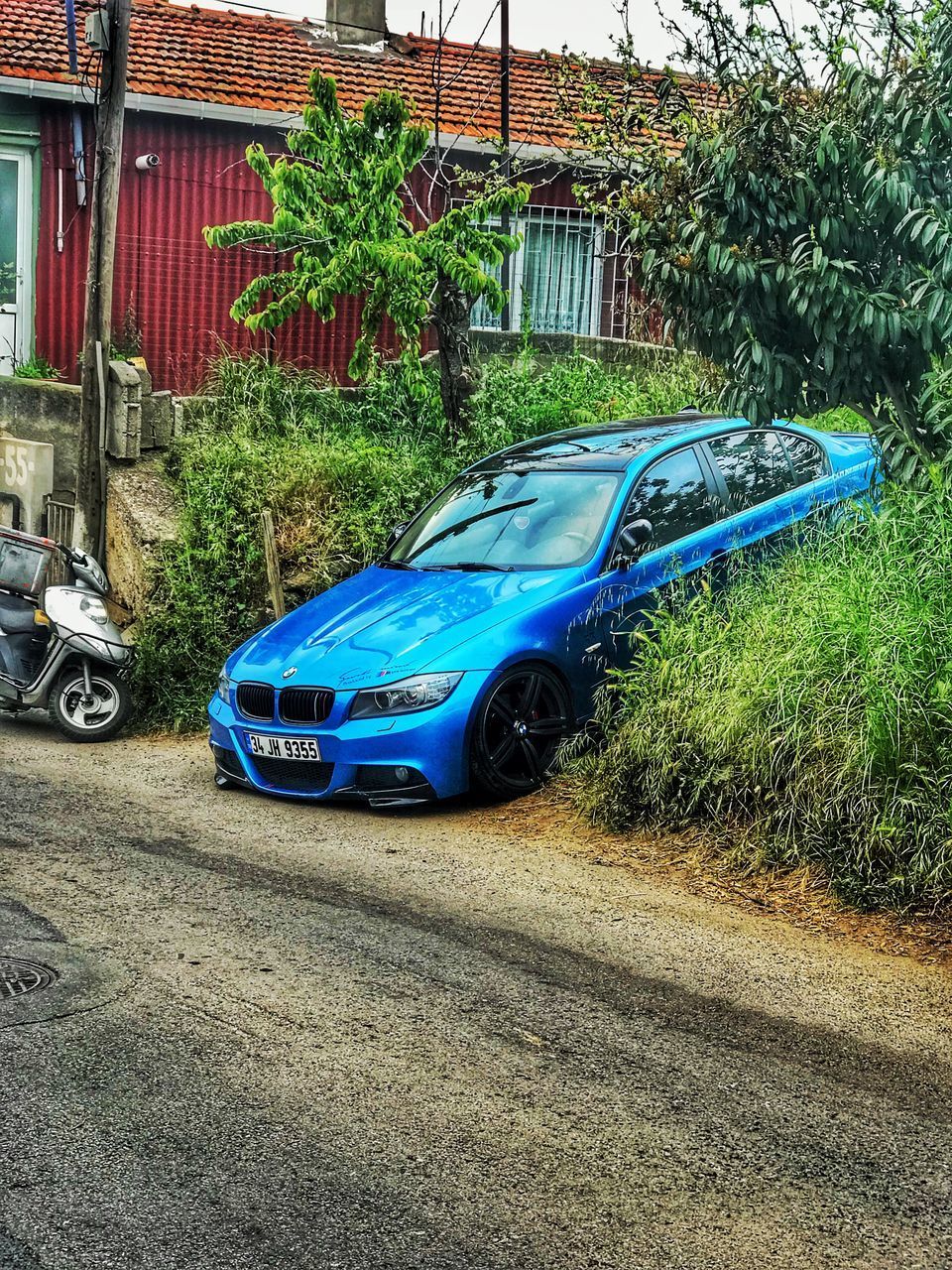 CAR PARKED BY ROAD IN CITY