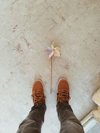 Low section of person standing on tiled floor