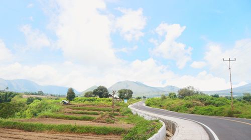 Road amidst landscape against sky