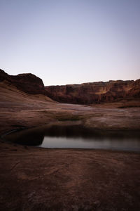 Scenic view of arid landscape against clear sky