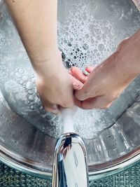 High angle view of hands washing in water