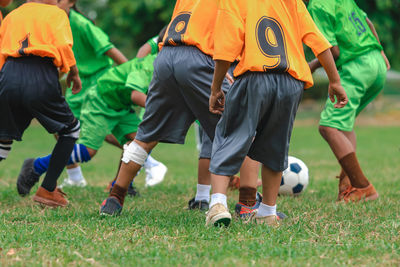 People playing soccer on field