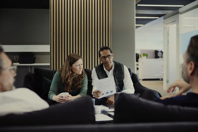 Group of business people having meeting in lobby