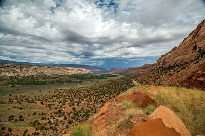 Scenic view of agricultural landscape against dramatic sky