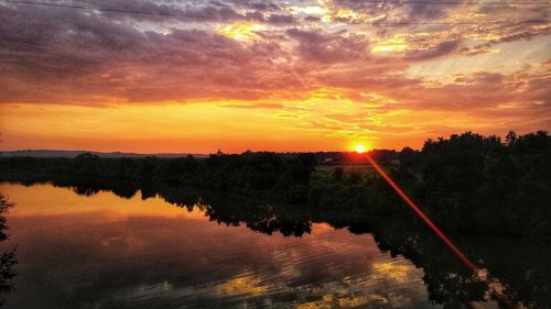 Scenic view of lake against romantic sky at sunset