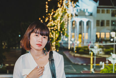 Portrait of young woman in city 