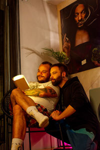 Young couple sitting at home