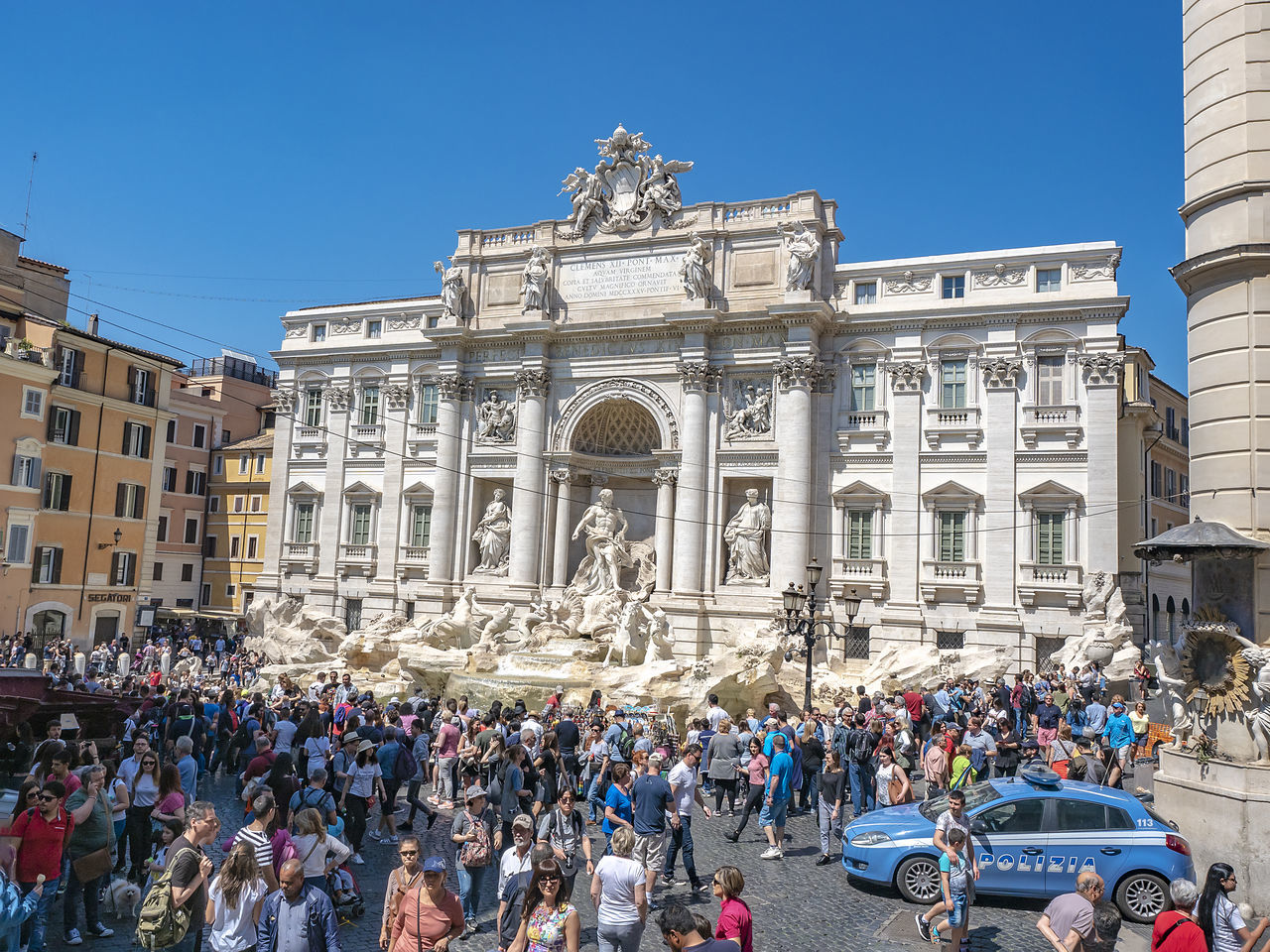 GROUP OF PEOPLE IN FRONT OF BUILDINGS