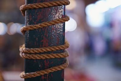 Close-up of rope tied up on rusty metal