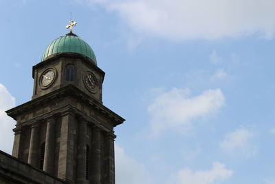 Low angle view of clock tower against sky