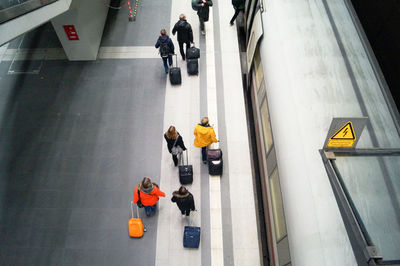 High angle view of people with luggage walking in station