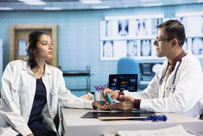 Female doctor examining patient in office