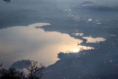 High angle view of city by trees against sky