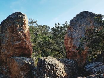 Low angle view of rock formation against sky