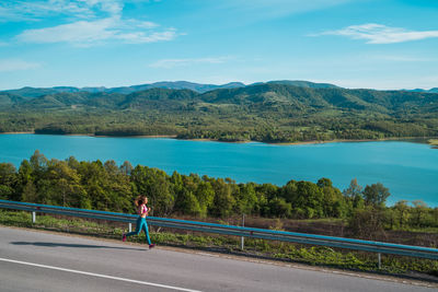 Man looking at view of mountain against sky