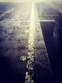 High angle view of road sign on wet street