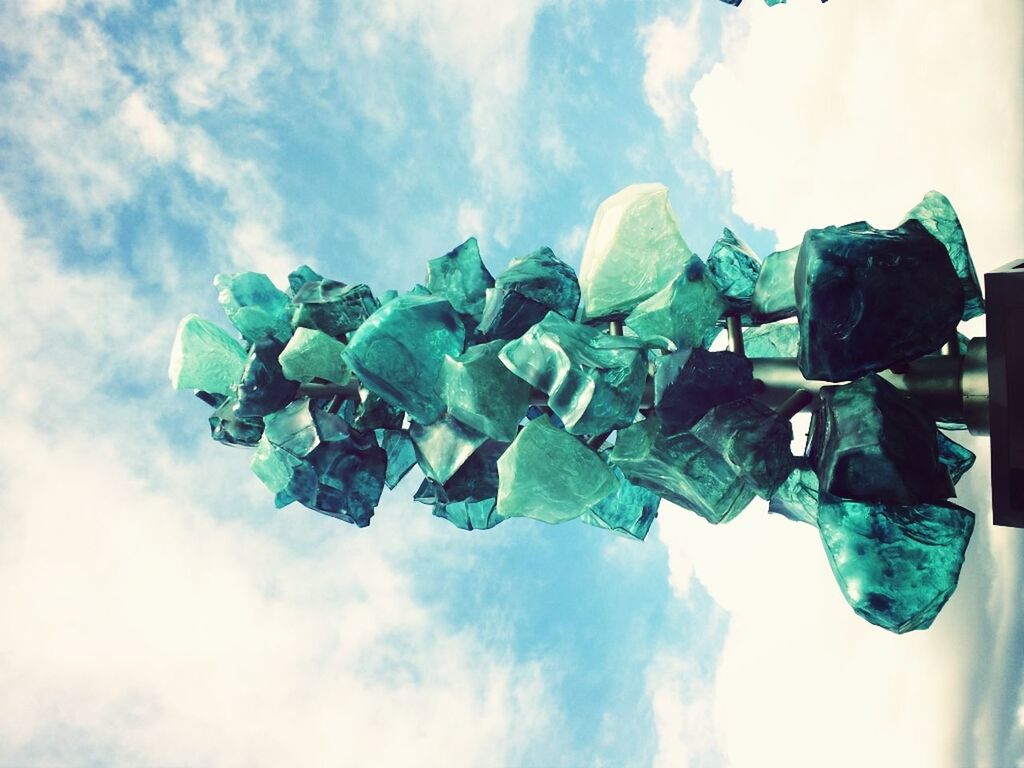 sky, low angle view, cloud - sky, blue, cloudy, cloud, in a row, day, large group of objects, nature, outdoors, green color, no people, arrangement, hanging, multi colored, side by side, abundance, sunlight, beauty in nature