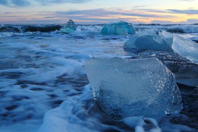Scenic view of drifting ices on the sea against sky during winter