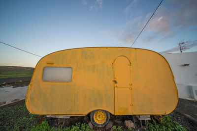 Yellow motor home against sky