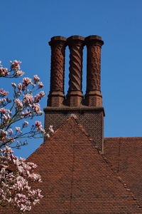 Low angle view of historical building against clear blue sky