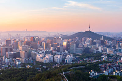 High angle view of buildings in city against sky during sunset