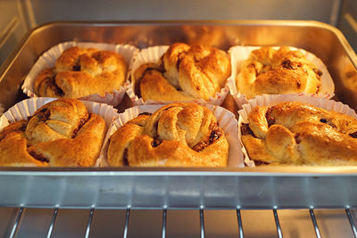 Chocolate pastries in baking tray on metal grate