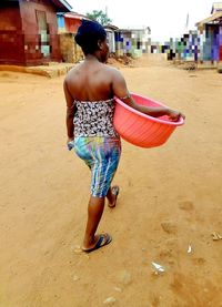 Rear view of woman walking on beach